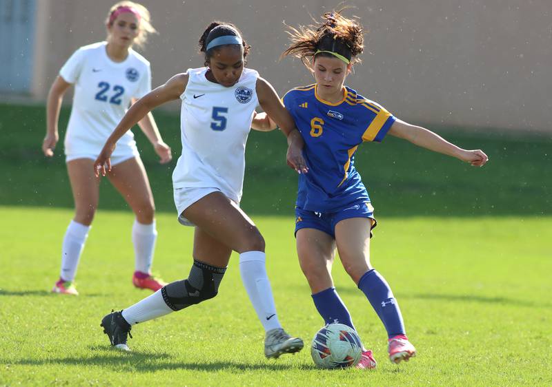 Johnsburg’s Liz Smith, right, battles Woodstock’s Salome Freites-Alvarado in varsity soccer on Wednesday, April 23, 2025, at Johnsburg High School in Johnsburg.