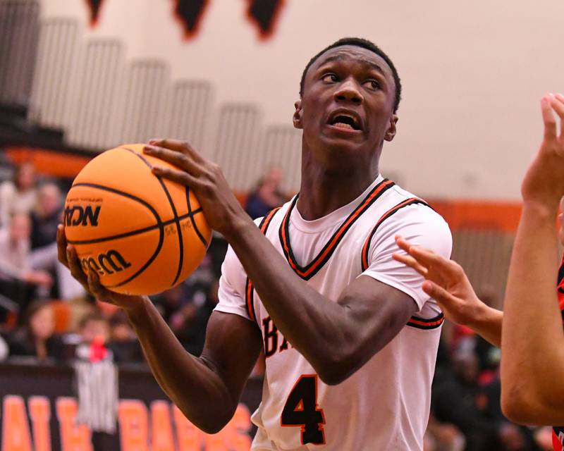 DeKalb's marquise bolden (4) goes up for a basket while being fouled during the game on Friday Dec. 27, 2024, while taking on Belvidere North during the 97th Chuck Dayton Classic Basketball tournament held in DeKalb.