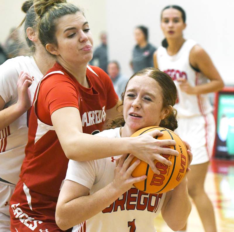 Oregon's Ashlee Mundell (1) battles an Aurora Christian player for the ball at the Oregon Girls Tip-Off Tournament on Friday, Nov. 21, 2025 at the Blackhawk Center  in Oregon.