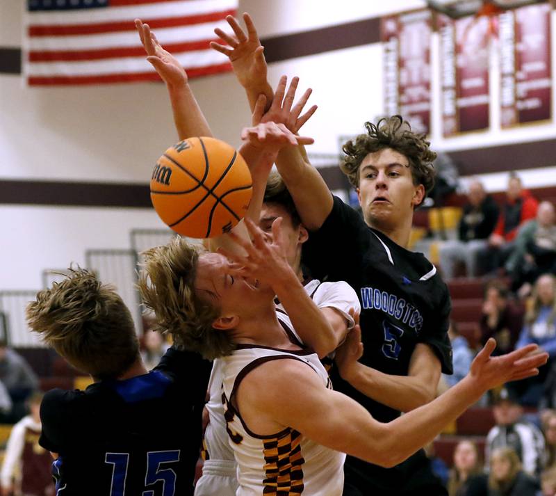 Woodstock's Liam Laidig (left) and Woodstock's Maxwell Beard (right) battle for a Demond with Richmond-Burton's Gavin Radmer (top0 and Ryan Wisniewski (bottom) during a Kishwaukee River Conference basketball game on Wednesday, Feb. 5, 2025, at Richmond-Burton High School.