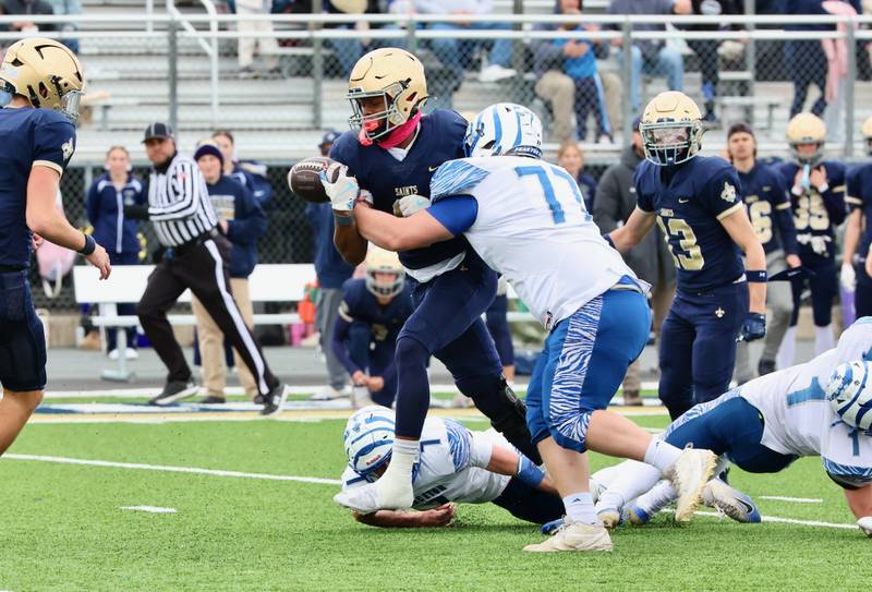 Princeton's Grady Cox puts the hit on Bloomington Central Catholic's Valshun Powe and causes a fumble in Saturday's 3A playoff opener in Bloomington.