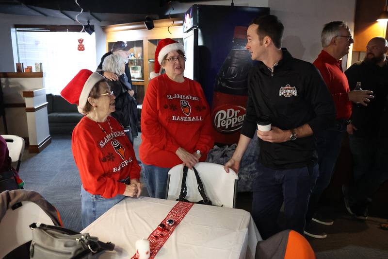 Slammers season ticket holders Sharon Bielfeldt, left, and Donna Kovak talk with new owner Night Train Veeck at the Joliet Slammers annual Holiday Open House on Saturday, December 2nd at Duly Health and Care Field in Joliet.