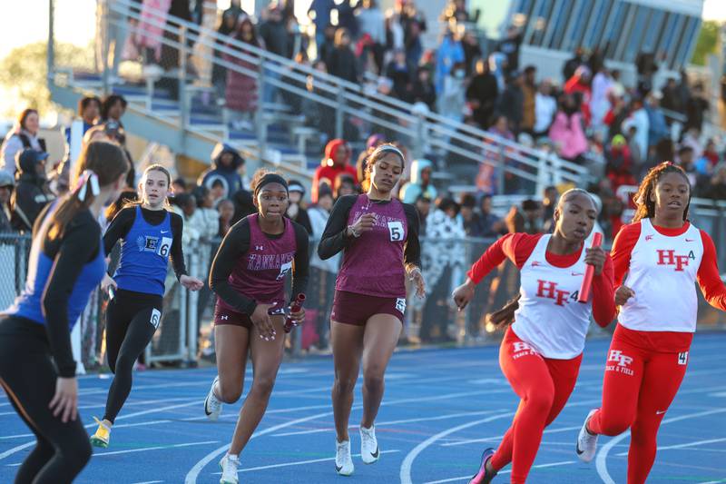 Kankakee runners execute the baton exchange in the 4x200 relay during the IHSA Class 3A Chicago Heights Girls Track and Field Sectional at Bloom High School on Wednesday, May 13, 2026. The Kays finished second with a time of 1:39.37 to qualify for state.