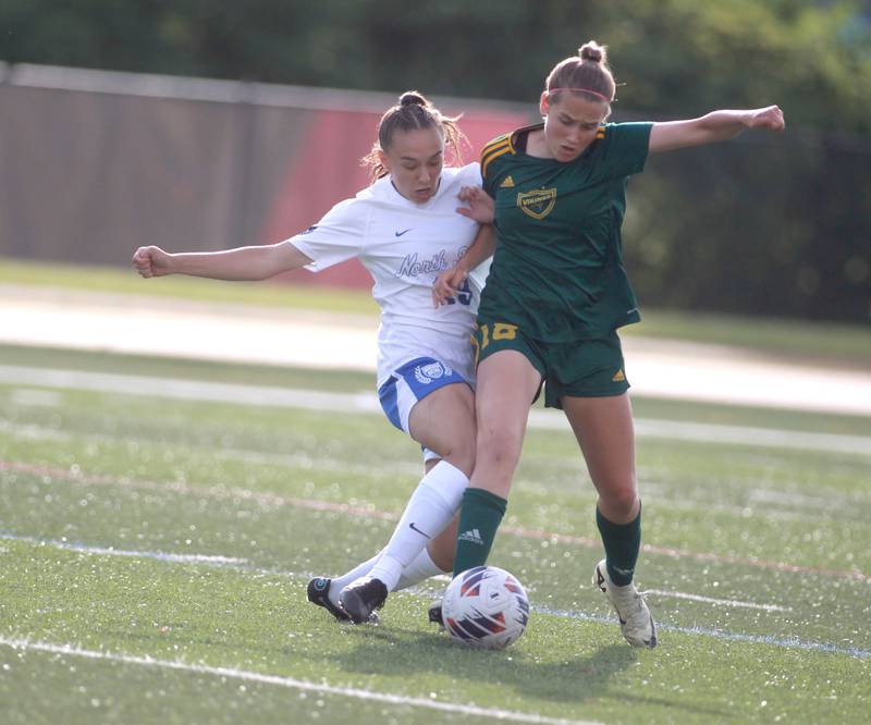 St. Charles North’s Laney Stark (left) and Fremd’s Natalia Dompke (right) go after the ball during the Class 3A state semifinal game at North Central College in Naperville on Friday, May 31, 2024.