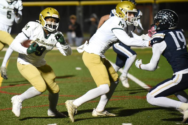 Bishop McNamara's Julius May, left, follows a block from Coen Demack on IC Catholic's Donnell Sallis during an IHSA Class 3A second round playoff game at IC Catholic Friday, Nov. 7, 2025.