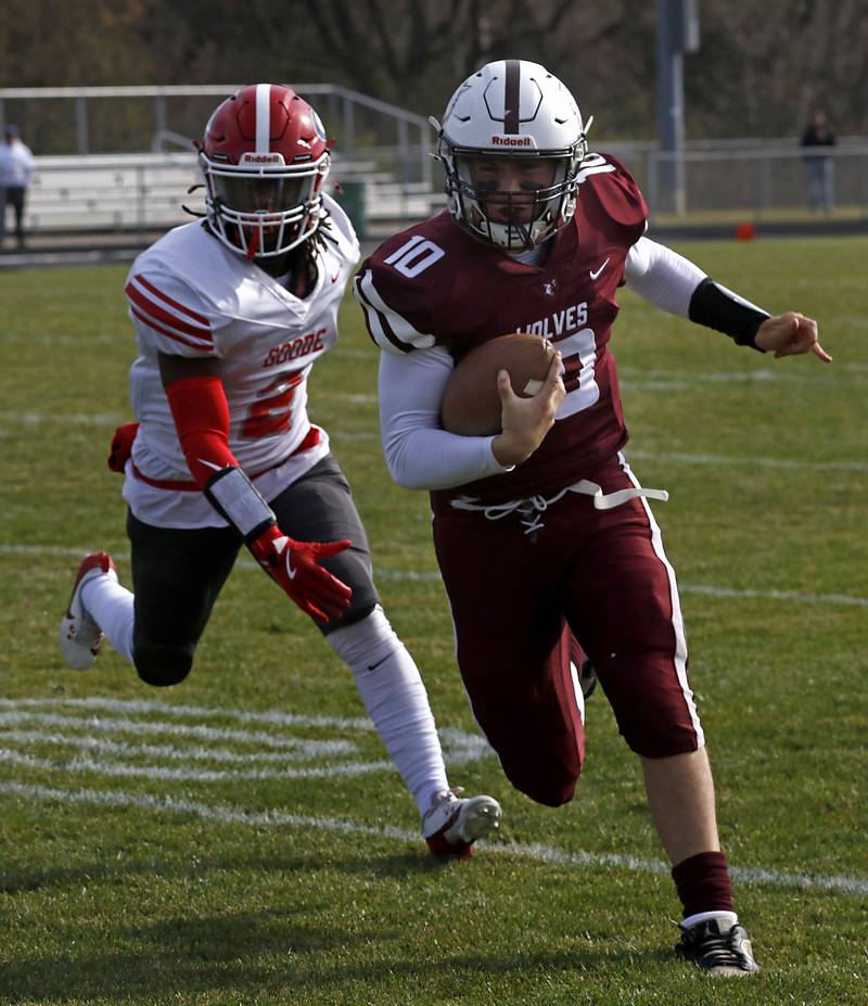 Prairie Ridge's Owen Satterlee runs the ball as Chicago Goode's Jacob McCain tries to catch him during an IHSA Class 5A first-round football game on Saturday, Nov. 2, 2024, at Prairie Ridge High School in Crystal Lake.