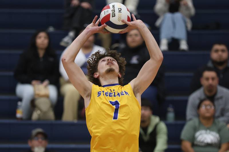 Joliet Central’s Logan Novak sets the ball against Joliet Catholic on Wednesday, April 1, 2026 in Joliet.