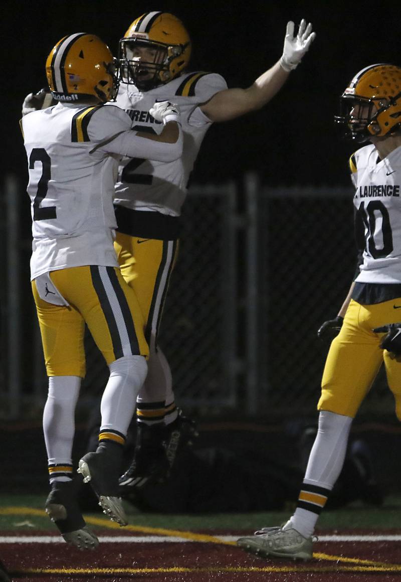St. Laurence's Harley Rizzs (right) celebrates his touchdown with teammate, Tim Hyland, during an IHSA Class 4A first-round football game against Richmond-Burton on Friday, Nov. 1, 2024, at Richmond-Burton High School in Richmond.