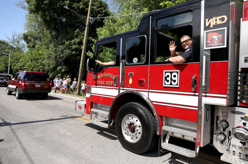Wheaton firefighters travel along Warrenville Road in Wheaton for the annual Memorial Day Parade on Monday, May 29, 2023.
