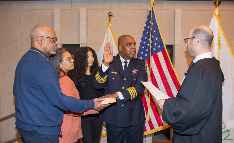 Sheriff John D. Idleburg takes his oath of office. At the ceremony (left to right) were Idleburg’s brother Donald; Sheriff Idleburg’s daughter Jennessa; Sheriff Idleburg’s granddaughter Daija; Sheriff Idleburg; and Deputy Chief Judge Shanes, who administered the oath of office.