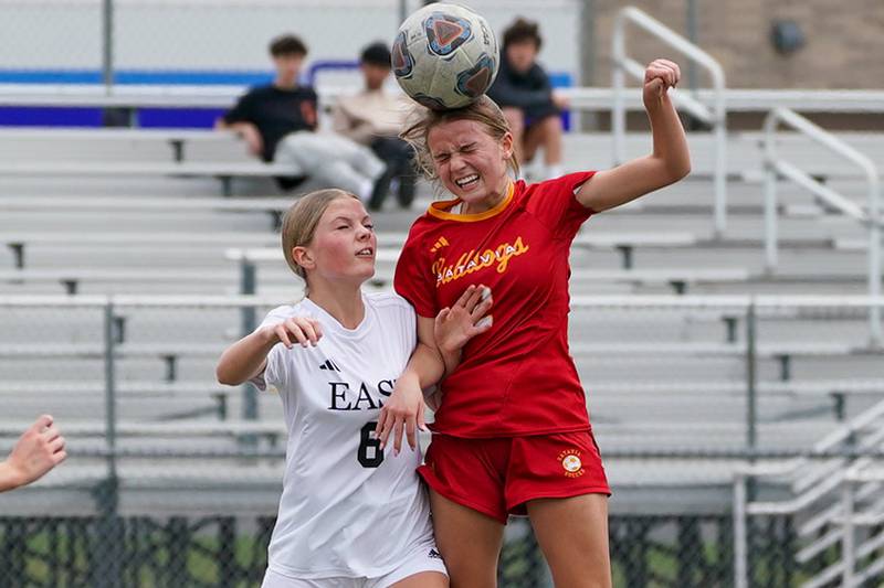 Batavia's Anna Grometer (right), goes up for a header against Oswego East's McKenzie Coleman (6) during a soccer match at Batavia High School on Saturday, March 29, 2025.
