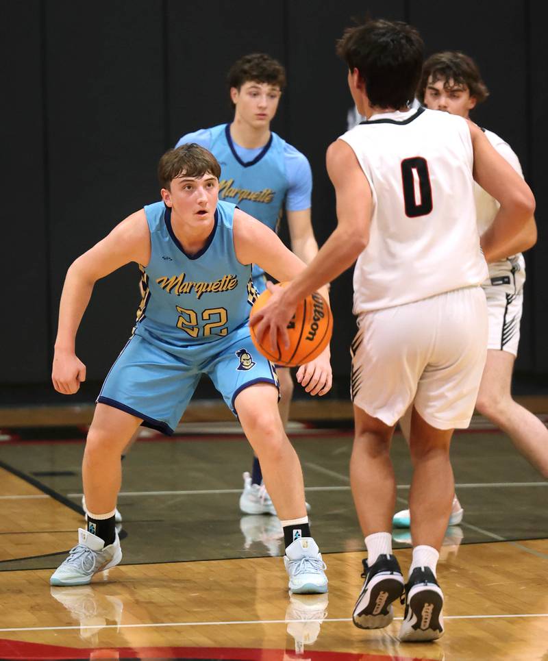 Marquette’s Griffin Dobberstein plays defense against Indian Creek's Cooper Rissman Monday, Dec. 9, 2025, during their game at Indian Creek High School in Shabbona.