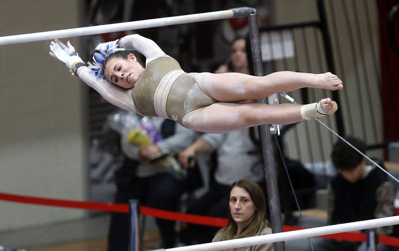Carmel’s Maddie Doyle competes in the preliminary round of the parallel bars on Friday, Feb. 20, 2026, during the IHSA Girls State Final Gymnastics Meet at Palatine High School.