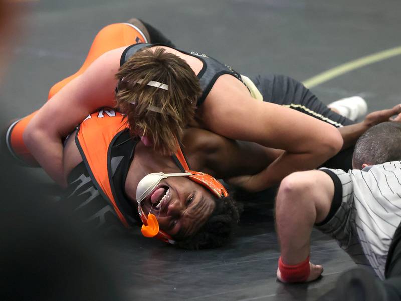 Sycamore’s Peter Gehrig tries to turn DeKalb’s Darius Russell during their 190 pound match Friday, Jan. 16, 2026, at Sycamore High School.
