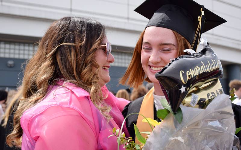 Sycamore High School graduate Paige Collie, right, embraces her mom, Denise Collie, after the commencement ceremony of Sycamore High School's Class of 2022, held Sunday, May 22, 2022 at Northern Illinois University's Convocation Center in DeKalb.