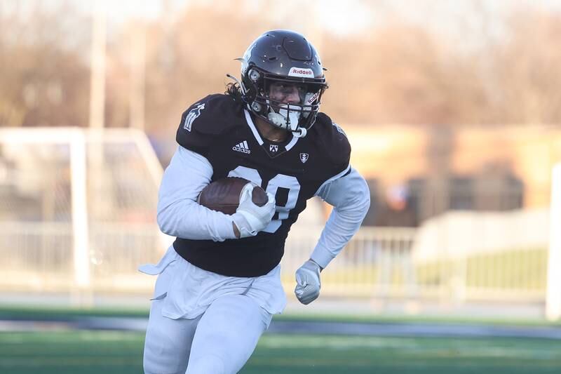 Joliet Catholic’s Nate Magrini rushes to the outside against Providence in the Class 5A semifinal on Saturday, Nov. 18, 2023, in Joliet.