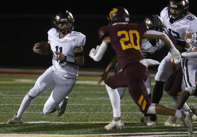 Sandwich's Nick Michalek tries to get around the corner as he is chased by Richmond-Burton's Luke Johnson during a Kishwaukee River Conference football game on Friday, Oct. 4, 2024, at Richmond-Burton High School.