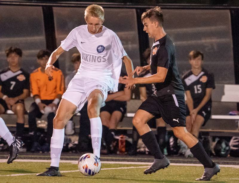 Geneva’s Karl gattinger (24) challenges Wheaton Warrenville South's Christian Triscik (8) for the ball during a soccer match at Wheaton Warrenville South on Wednesday, Sep 13, 2022.
