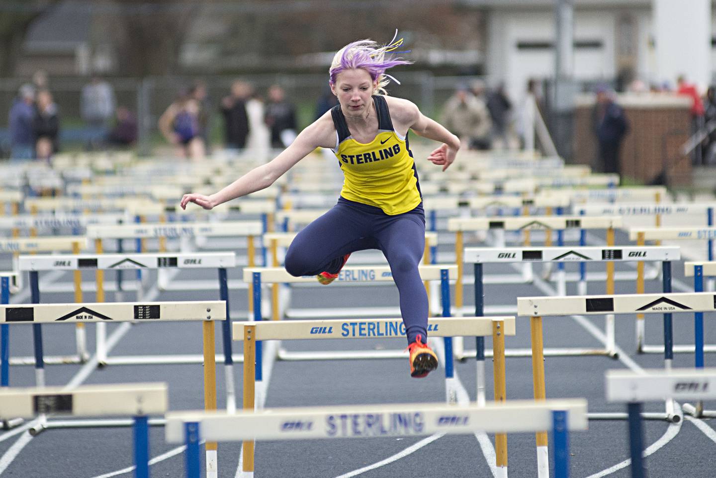 Sterling's Addison Robbins clears the final hurdle in the 4x100 shuttle hurdles Friday, April 29, 2022 at the Sterling Night Relays.