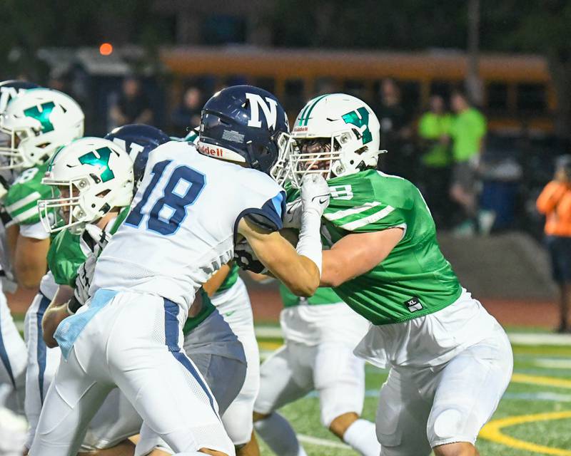York’s Joe Reiff, right, tries to block Nazareth Academy Nazareth Academy Jake Pinckney (18) during the first quarter in Elmhurst on Friday Sep. 1, 2023.