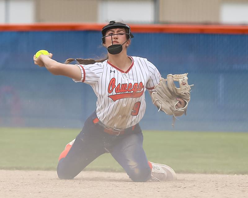 Oswego's Maddie Hernandez (9) throws to first base from her knees during Class 4A Oswego Regional final softball game between Yorkville at Oswego. May 24th, 2024.