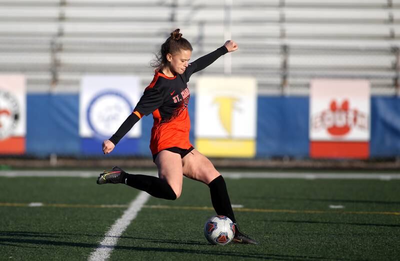St. Charles East’s Anna Champine kicks the ball during a Tri-Cities Night game against St. Charles North at Geneva High School on Tuesday, April 26, 2022.
