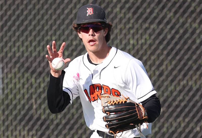 DeKalb's Cole Latimer fields a ball barehanded in center field during their game against Neuqua Valley Tuesday, May 7, 2024, at DeKalb High School.