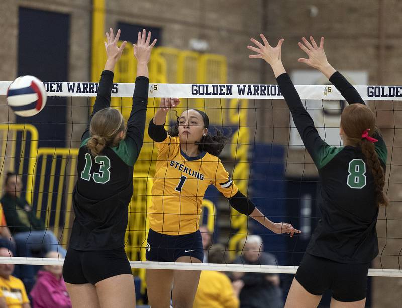Sterling’s Nia Harris (left) hammers a shot against Alleman Tuesday, Oct. 22, 2024, in Sterling.
