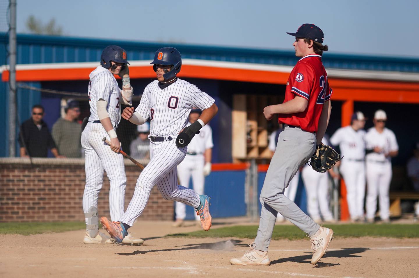 Oswego’s Gabriel Herrera (8) scores on a wild pitch during a baseball game against West Aurora at Oswego High School on Thursday, April 25, 2024.