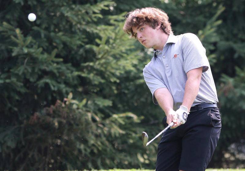 DeKalb golfer Brett Paeglow hits a chip shot during his round Monday in the Mark Rolfing Cup at the Kishwaukee Country Club in DeKalb.