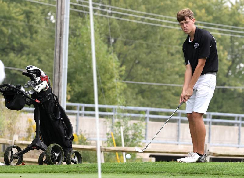 Kaneland’s Brian Davoust chips onto the ninth green Wednesday, Sept. 27, 2023, during the Class 2A boys golf regional at Sycamore Golf Club.