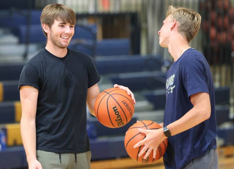Hiawatha’s Aidan Cooper (left) talks to second-year head coach Matthew Montavon during practice Thursday, June 13, 2024 at the school in Kirkland.