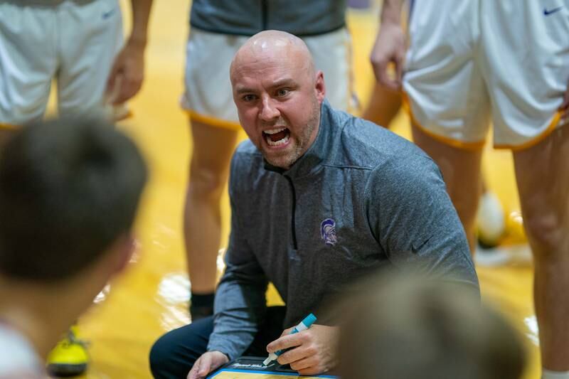 Downers Grove North's head coach Kyle Briscoe talks to his players during a break in play against York during a basketball game at Downers Grove North High School on Friday, Dec 9, 2022.