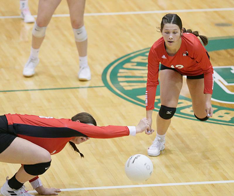Henry's Harper Schrock (24) misses a return from St. Bede as teammate Kaitlyn Anderson (12) watches the ball fall onto the court in the Class 1A semifinal game on Wednesday, Oct. 16, 2022 at St. Bede Academy in Peru.