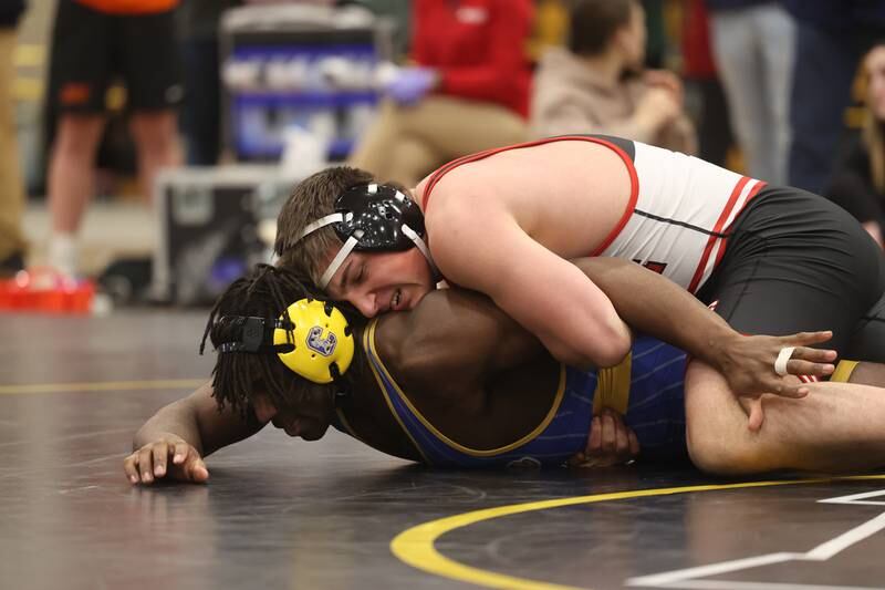 Luke Chrisse of Yorkville works over Charles Walker of Joliet Central in the 215-pound weight SPC Conference championship match at Joliet West on Saturday, Jan 25, 2025.