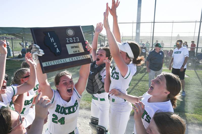 Rock Falls pitcher Katie Thatcher (24) yells with excitement as she raises the Class 2A Stillman Valley Sectional championship plaque Friday after the Rockets defeated Marengo.