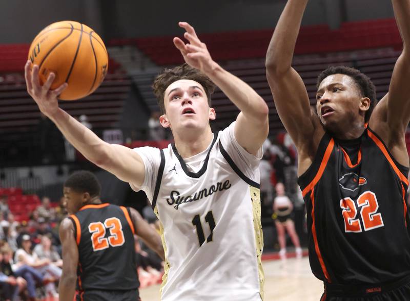 Sycamore's Jake Shipley shoots in front of DeKalb's Justin O’Neal during their game Friday, Jan. 31, 2025, in the FNBO Challenge in the Convocation Center at Northern Illinois University in DeKalb.