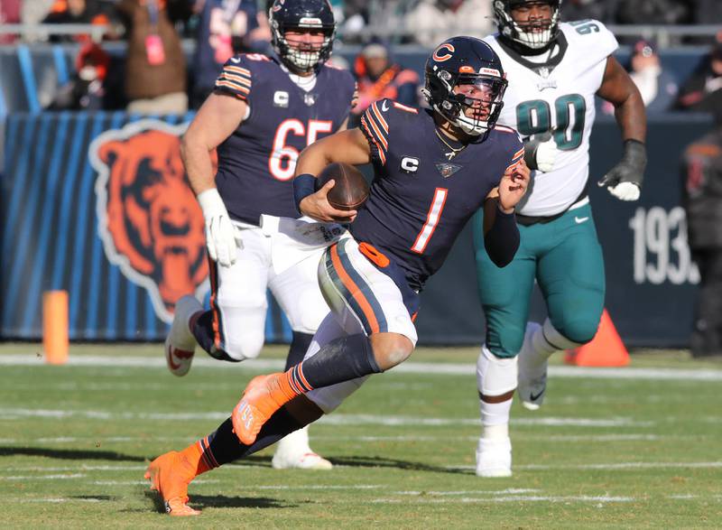 Chicago Bears quarterback Justin Fields carries the ball for a long run after breaking through the Eagles defensive line during their game Sunday, Dec. 18, 2022, at Soldier Field in Chicago.
