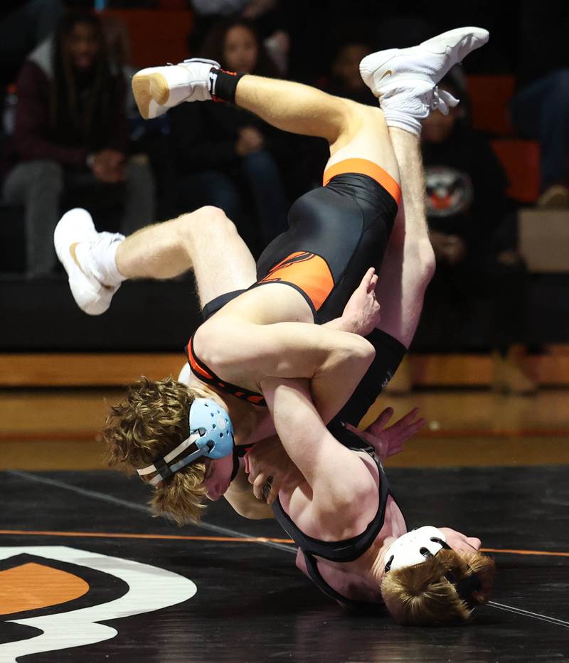 DeKalb’s Ayden Shuey (top) and Sycamore’s Thomas Lind get tangled up Friday, Jan. 17, 2025, during their 132 pound match at DeKalb High School.