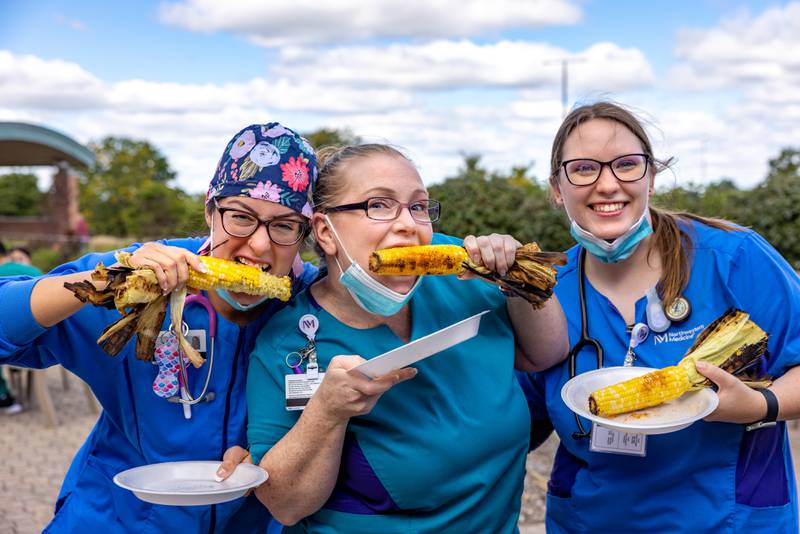 Nurse Carlien Van Jaarsveld, from left to right, patient care technician Tabitha Pulkowski and nurse Emily Anderson, staff at Northwestern Medicine McHenry Hospital, enjoy a corn roast hosted to celebrate the hospital's improved rankings.