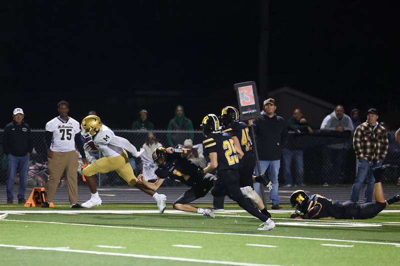 Bishop McNamara's Julius May breaks away from Herscher defenders for an 87-yard touchdown to secure a 38-28 lead near the end of the fourth quarter during the Fightin' Irish's 45-28 victory over Herscher on Friday, Sept. 5, 2025.