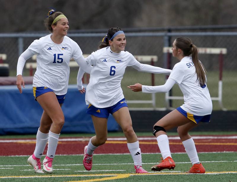 Johnsburg's Elizabeth Smith (center) celebrates her goal with teammates, Lauren McQuiston, (left) and Johnsburg's Charlie Eastland (right) during a Kishwaukee River Conference soccer game against Richmond-Burton on Tuesday, April 1, 2025, at Richmond-Burton High School.