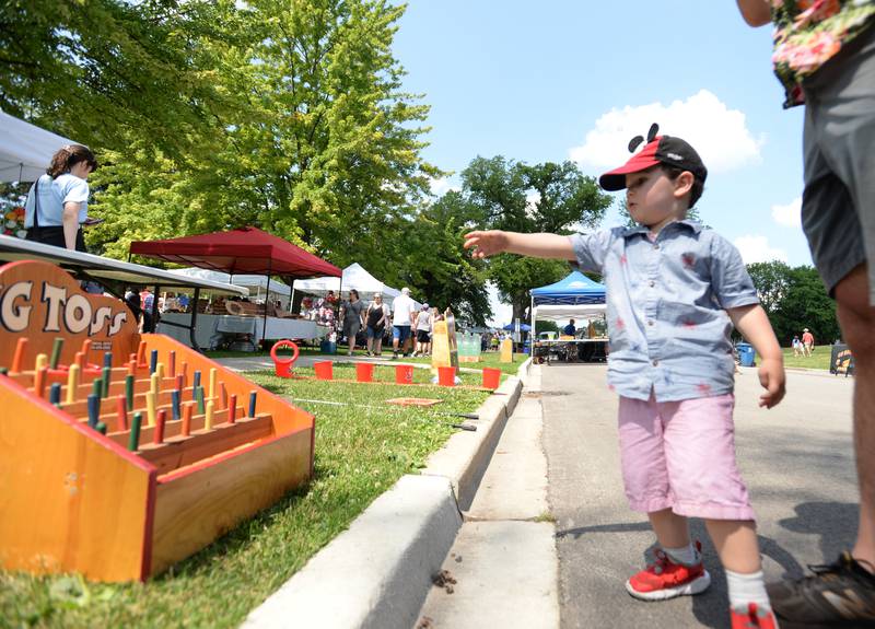 (Jasper Parrilli- Trumbil of Chicago plays one of the games at the Hinsdale 4th of July Family Festival Tuesday June 4, 2023.