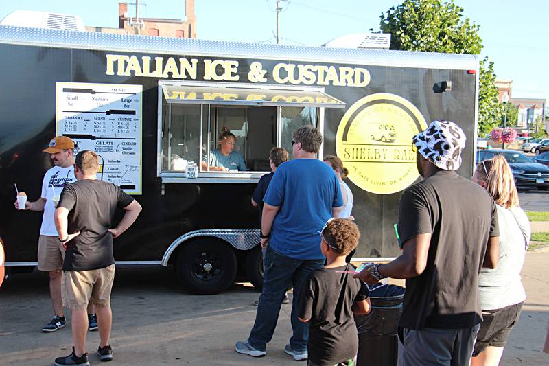 Visitors line up in front of Shelby Rae's Italian Ice & Custard at Venetian Night Saturday, August 12, 2023 in Dixon.