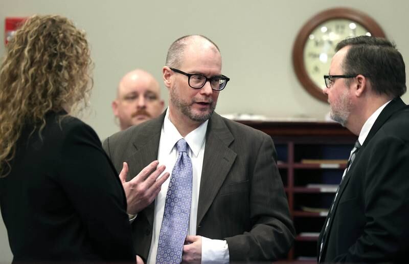 Jonathan Hurst (center) talks to his attorneys Thursday, Jan. 23, 2025, during his trial at the DeKalb County Courthouse in Sycamore. Hurst is charged in the 2016 killings of elderly mother and son Patricia and Robert Wilson of Sycamore.