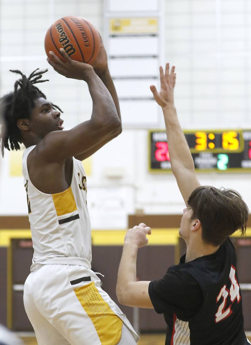 Jacobs' Treval Howard shoots the ball over Huntley's Ryan Sweeney during a Fox Valley Conference boys basketball game on Wednesday, Dec. 6, 2023, at Jacobs High School in Algonquin.