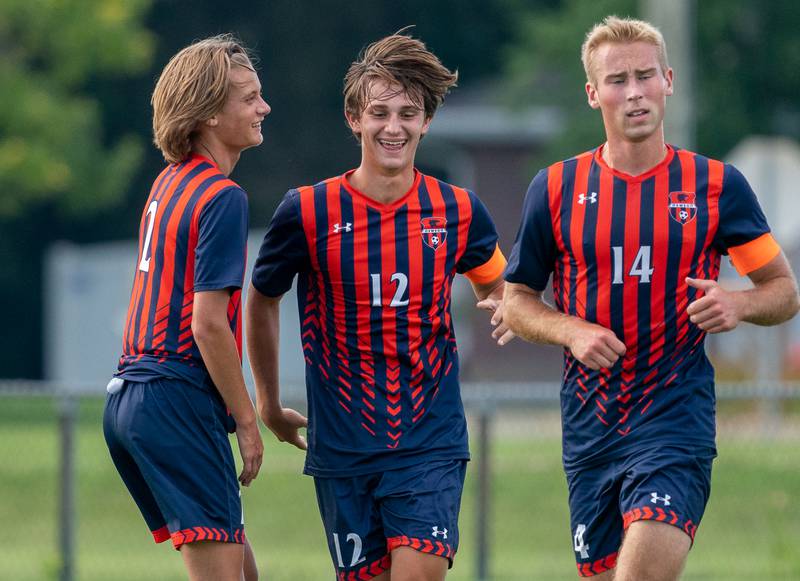 Oswego’s Ryan Walsh (12) smiles after scoring a goal against Wheaton Warrenville South during a soccer match at Oswego High School on Thursday, Aug 25, 2022.