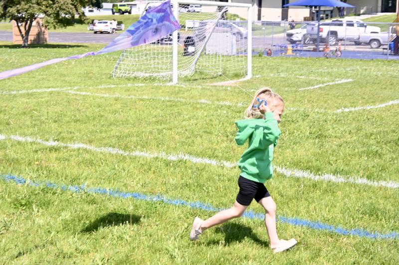Quinn McGuire, of Ottawa, runs with her Frozen kite on Sunday, May 18, during the 5th annual Kites in Flight festival at Peck Park in Ottawa.