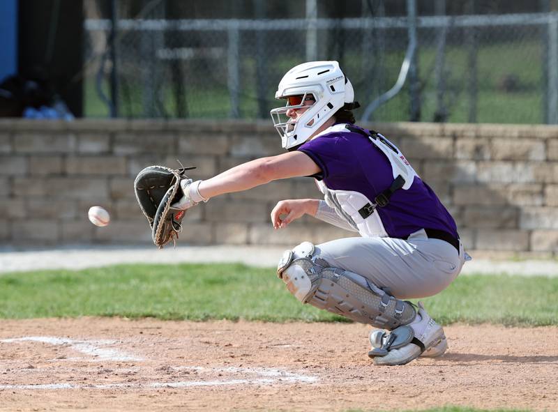 Downers Grove North's catcher Jimmy Janicki warms up during the boys varsity baseball game between Lyons Township and Downers Grove North high schools in Western Springs on Tuesday, April 11, 2023.
