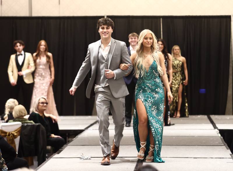 Montini Catholic seniors Dominic Catalano and MaryKate Lewan walk the runway during the school's 40th annual fashion show fundraiser.